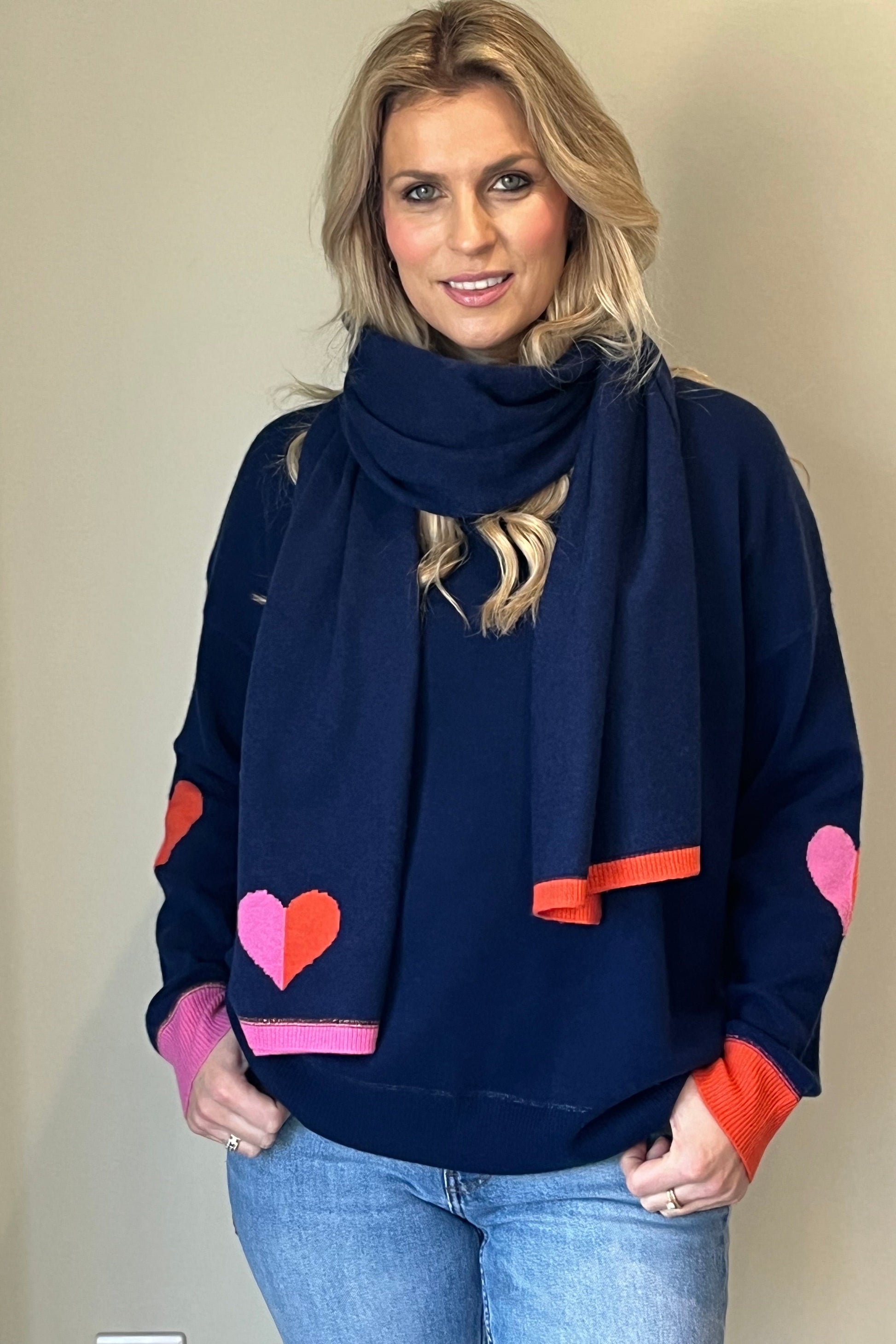 Navy cashmere scarf  with heart intarsia in pink and orange finished with contrast ribbed tips